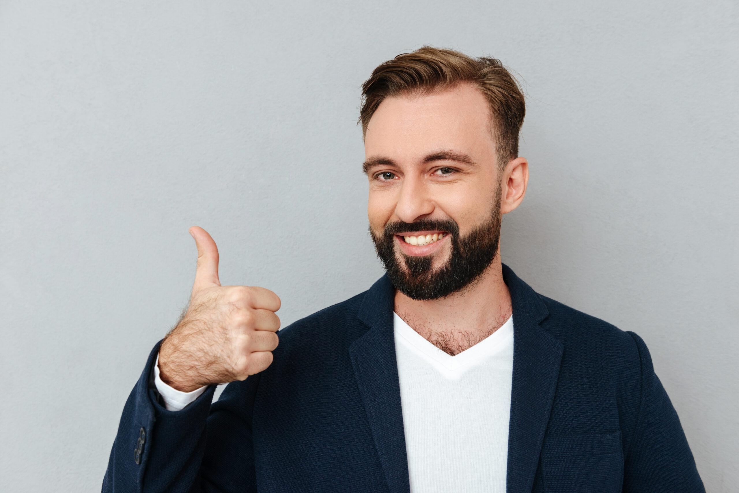 Cheerful bearded man in business clothes showing thumb up Tom R.